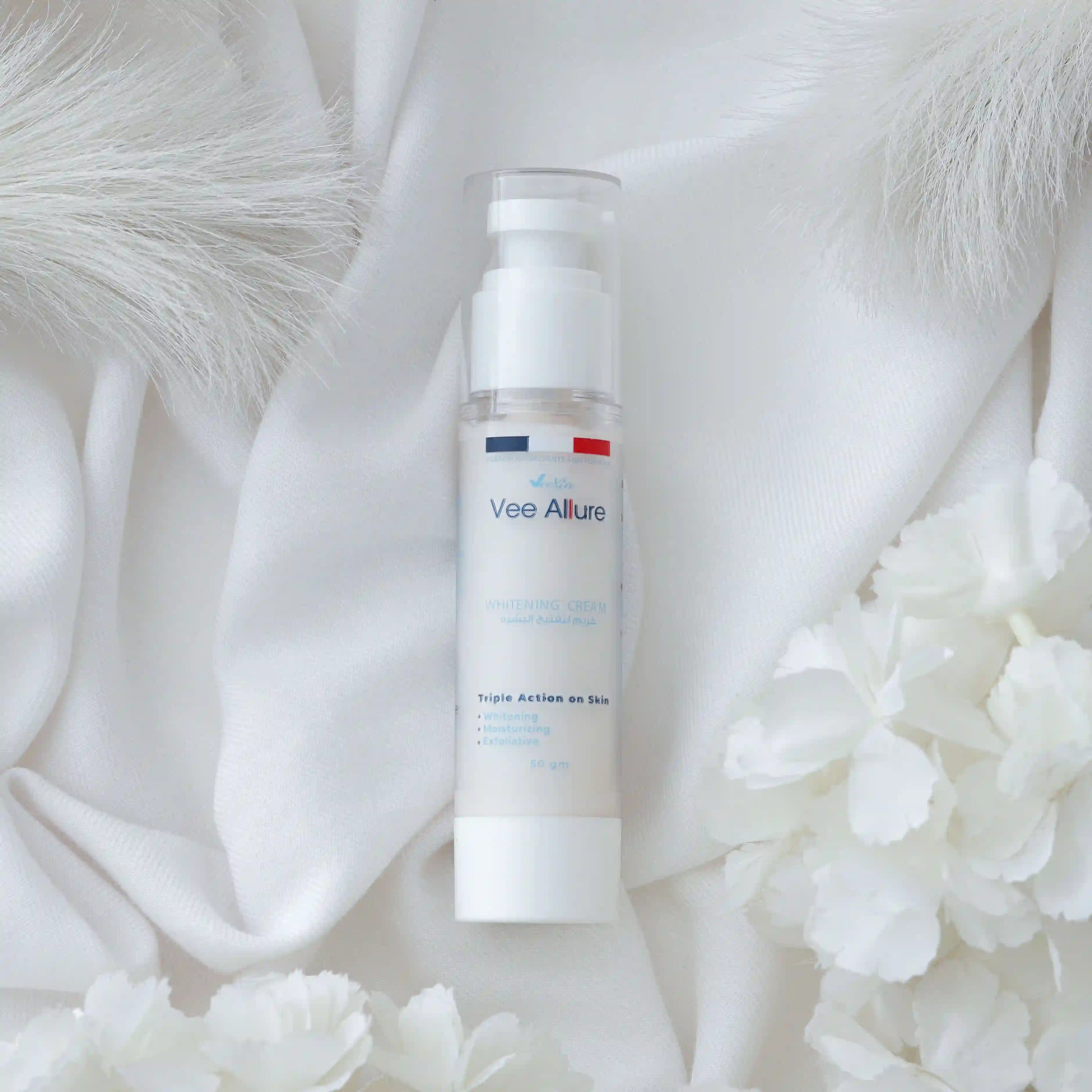 Vee Allure Whitening Cream bottle on white fabric with white flowers for face and body brightening